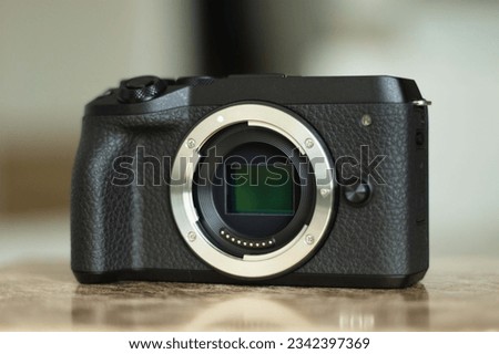 Compact, professional mirrorless camera with exposed sensor. 