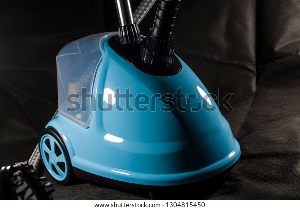 The compact, small vacuum cleaner for the
house of blue color. Cleaning. Equipment. Modern technologies.
Lovely appearance. Black
background.