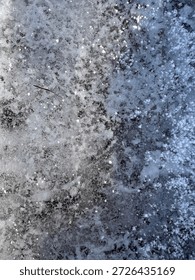 compact snow surface flat lay view. Snow surface shown granular, photographed with natural light, presented with visible surrounding space, suitable for neutral winter textures and background.