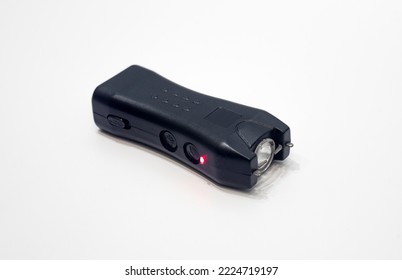 Compact Stun Gun On White Isolate. An Electric Shocker With A Flashlight For Self-defense.Protection From Dogs And Criminals.