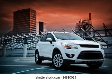 A Compact SUV In The City. Dramatic Sky.