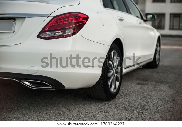 \
Compact white executive car, with beautiful\
wheels, large chrome\
grille.