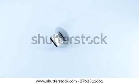 Compact white USB wireless dongle for computer peripheral connectivity isolated on a plain white studio background for modern technology concepts