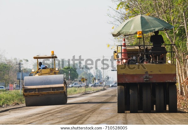 Compaction machinery for rail road\
construction in Chiang Mai, Thailand.\
Grader is working on a road\
construction site to smooth the\
ground.