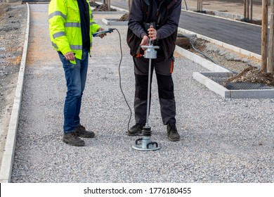 Compaction tests with lightweight deflectometer. Measuring subgrade and subbase layers percents of compaction to improve the quality of construction site.