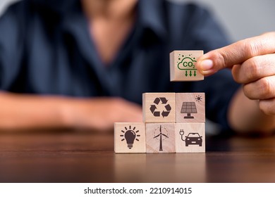 Companies are targeting net zero greenhouse gas emissions. Carbon credit concept.Tradable certificate to drive industry in direction of low emissions in efficiency cost. Wooden cubes with decrease CO2 - Shutterstock ID 2210914015