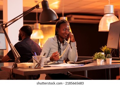 Company Employee Answering Landline Phone Call To Talk About Business Research With Project Manager. Having Remote Conversation On Office Telephone Line, Chatting About Email Report.