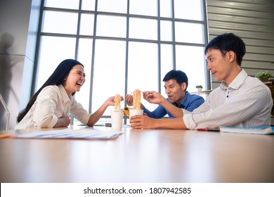 Company Employee Have A Cozy  Lunch  Break  With Cup Noodle Together With Smile  In Meeting Room