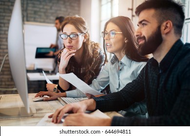 Company Employees Working In Software Development And Designer Office