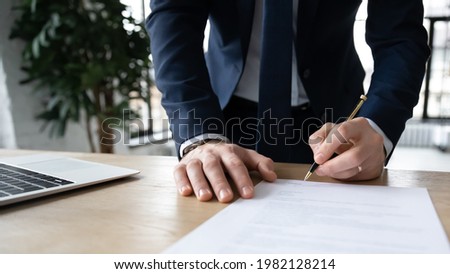 Company executive, business owner, employer signing contract, agreement, paper report at workplace. Businessman affixing signature, hiring employee, buying or selling project, closing deal. Close up