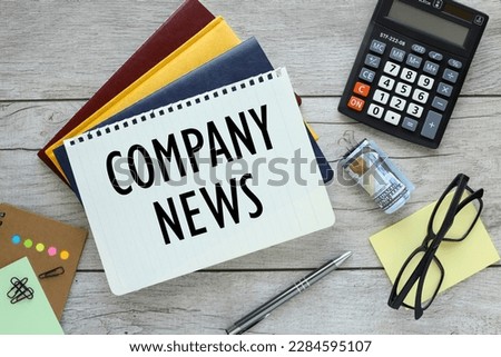 Company News text on a notepad, three notepads on the desktop. conceptual background