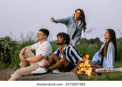 A company of young cheerful friends sitting by the fire, chatting and admiring the view. - Powered by Shutterstock