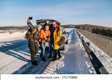 The Company Of Young People Traveling By Car On Winter Road. Stopped To Take A Pictures Of Themselves.