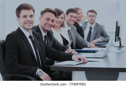 Company's Shareholders At The Meeting Sitting Behind A Desk With