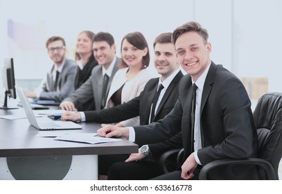 Company's Shareholders At A Meeting At Work, Sitting At A Table 