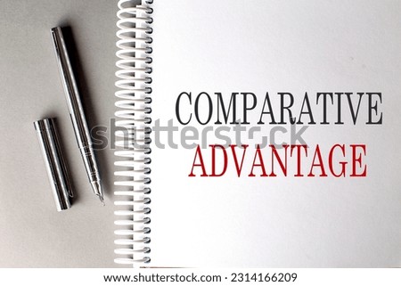 COMPARATIVE ADVANTAGE text on notebook with pen on grey background