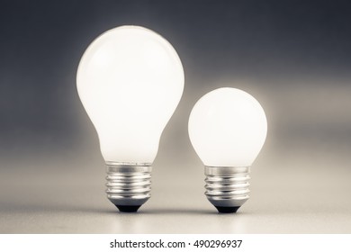 Comparative Big And Small Light Bulb, Small And Medium Sized Business, Coaching, Training, Or Other Comparison Concept