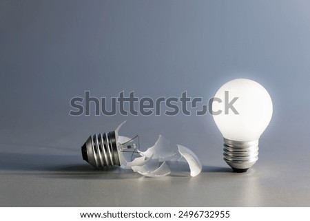 Comparative a broken and a glowing light bulb, old and new idea, failure and success, self development, and learning from mistakes