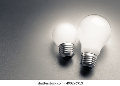 Comparative Small And Medium Size Of Light Bulb, Small And Medium Sized Business, Coaching, Training, Or Other Comparison Concept