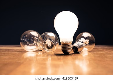 Comparative white light bulb standing on the table