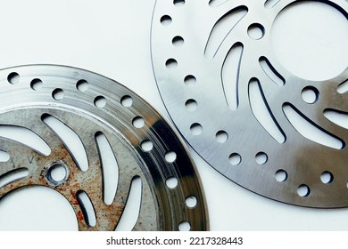 Compare New And Old Motorcycle Brake Discs, Objects On A White Background