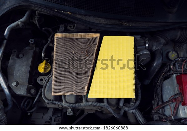 Comparison new clean and\
dirty used engine air filter for car. Engine background. Auto spare\
part