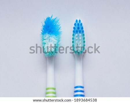 Comparison of the old and new toothbrushes in macro view, showing different bristle conditions: time to change a new toothbrush