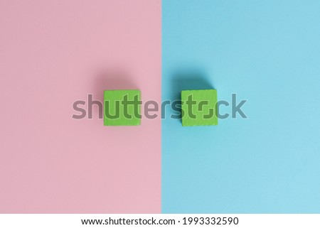 Comparison of Two Objects Blocks Pencils Sticker Notes Facing Inward Outward Making An Arrangement Reflection On a Separated Coloured Background Shot In A Flat Lay Perspective