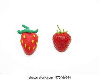 Comparison of two strawberries - Real and Fake. - Shutterstock ID 473466544