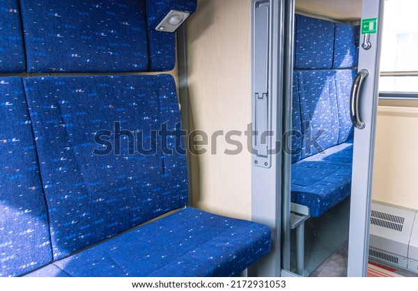 A compartment in a\
long-distance carriage on the railway. Passenger rail\
transportation. The lower bed and the sliding mirror door in the\
compartment of the passenger\
car.