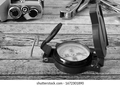Compass, camera and multitool on the table