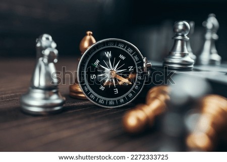 compass and chess piece on chess board game for ideas, challenge, leadership, strategy, business, success or abstract 