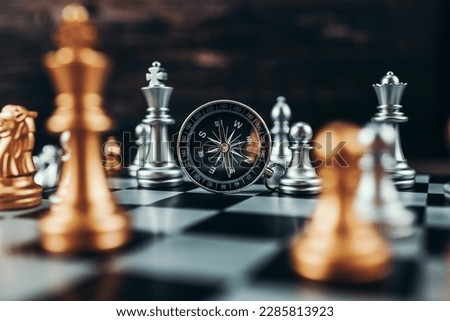 compass and chess piece on chess board game for ideas, challenge, leadership, strategy, business, success or abstract 