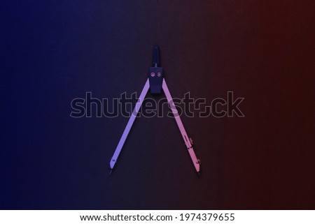 Compass for drawing in neon light. Top view. Stationery. Engineering