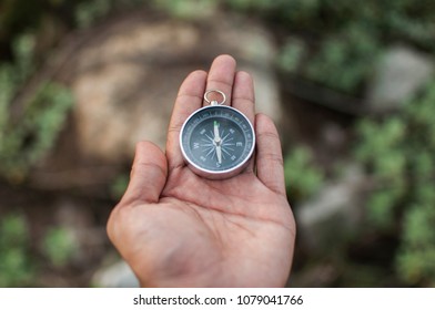 compass in hands in the open air - Shutterstock ID 1079041766