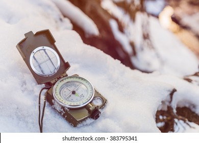 Compass Instrument On Snow. Winter Mountain Trip Concept