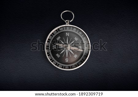 Compass isolated on dark background. Close-up.