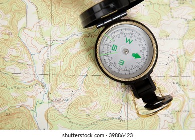 Compass Laying On A Topographical Map