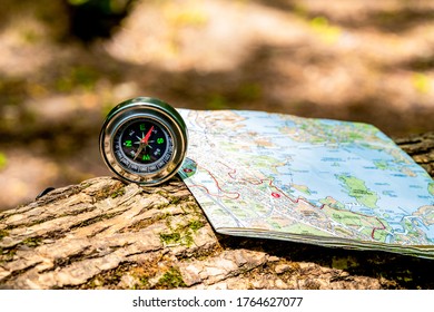 compass and map lie on a stump