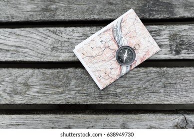 Compass And Map On A Beautiful Wooden Surface. Top View