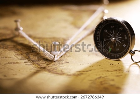 Compass and Map with Push Pins Symbolizing Travel Planning and Exploration