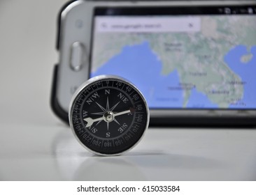 Compass and map for travel under planning direction isolated on white background