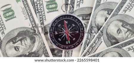 Compass and money dollars financial course for money investment. Bank loan and cash income growth concept