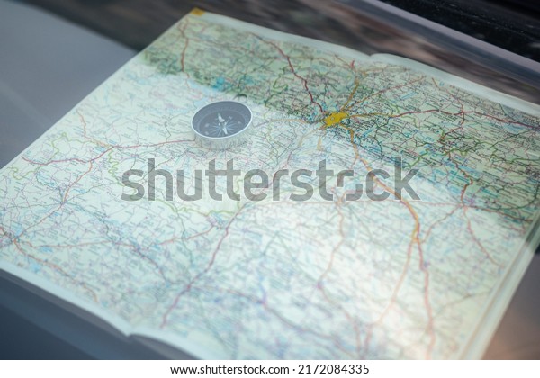 Compass on a map\
behind the mirror of a\
car