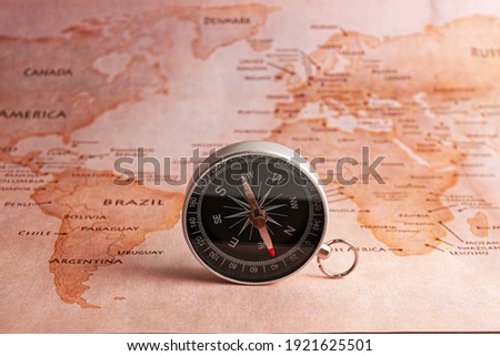 Compass on the map. The oldest navigation device to navigate the world. Travel, tourism, exploration and adventure while on vacation.