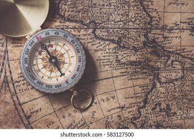 Compass on old map - Shutterstock ID 583127500