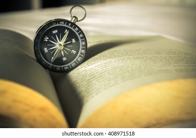 Compass On Open Old Book