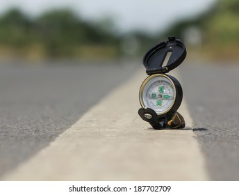 Compass on the road , Blur background in the area of confusion - Shutterstock ID 187702709