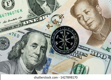 Compass On US America Dollar And Chinese Yuan Banknotes Using As Tariff Or Trade War Negotiation Or Future Direction Between The US And China Concept.