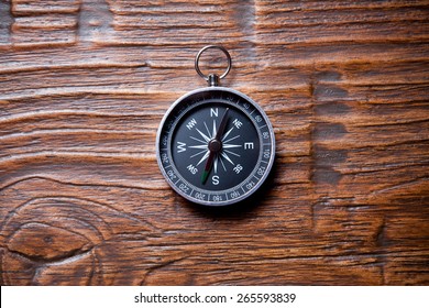 compass on wooden background with space for text - Shutterstock ID 265593839